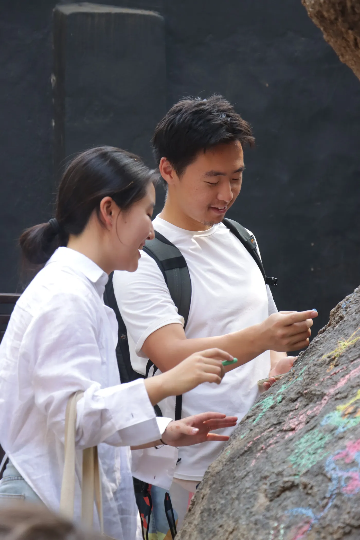 Napkins and drawings spread across a table, with visitors working on them and the courtyard visible below.