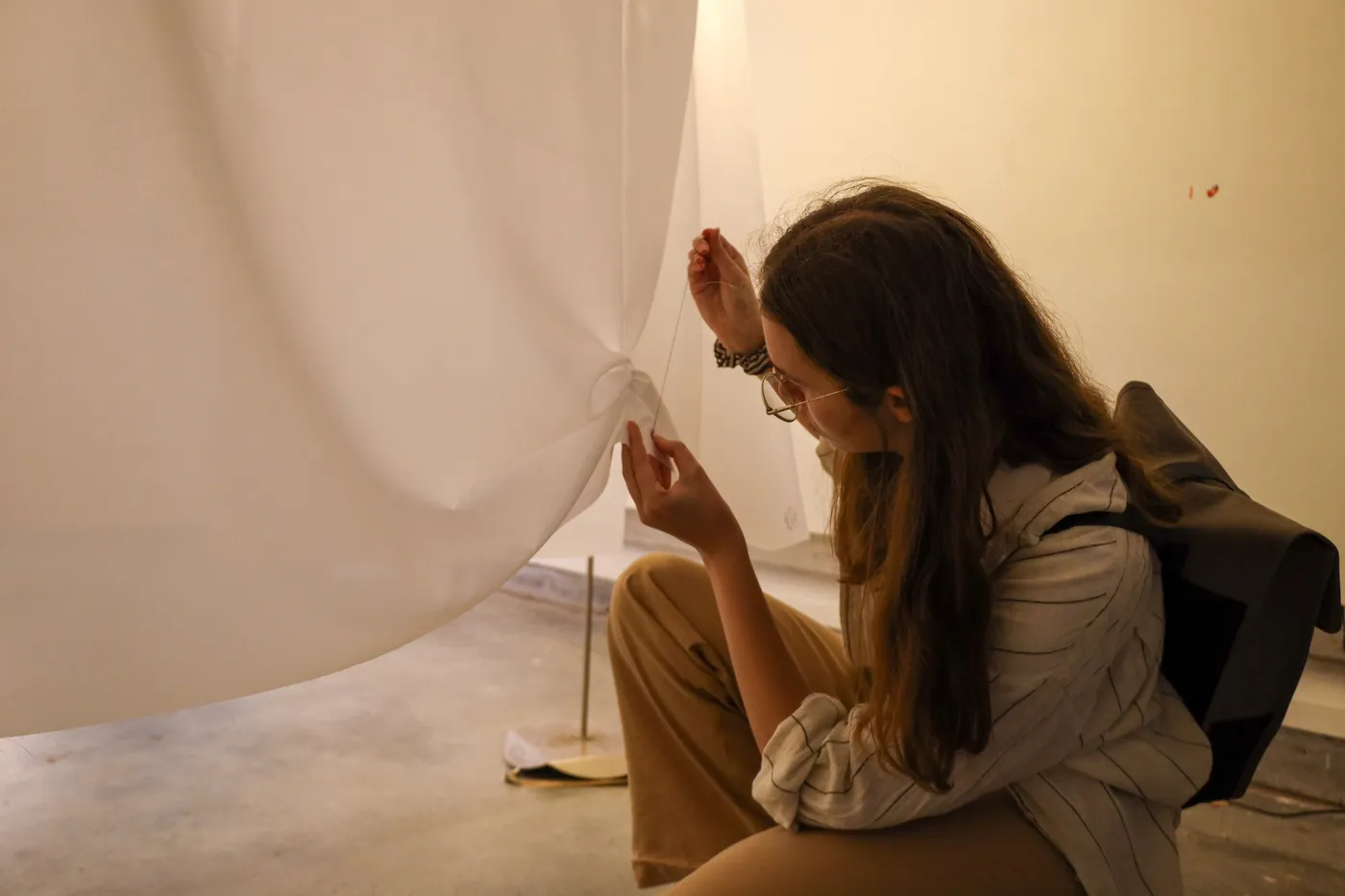 A visitor stepping between two of the hanging layers.