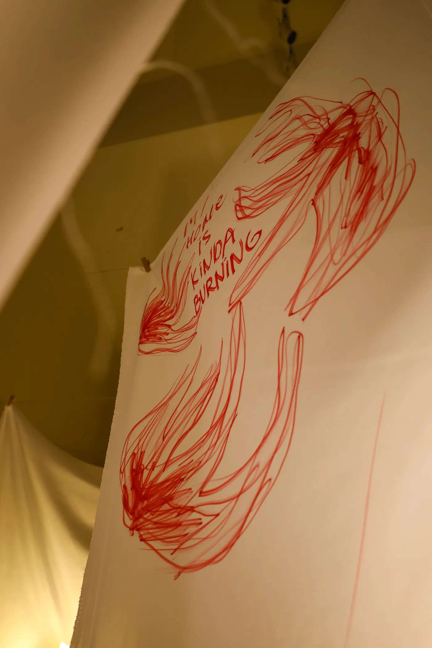 The finished tunnel of drawn sheets, lit by standing lamps.